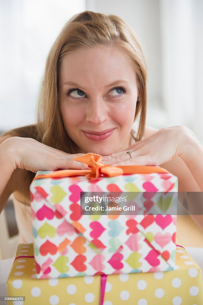 USA, New Jersey, Jersey City, Portrait of young woman with wrapped presents