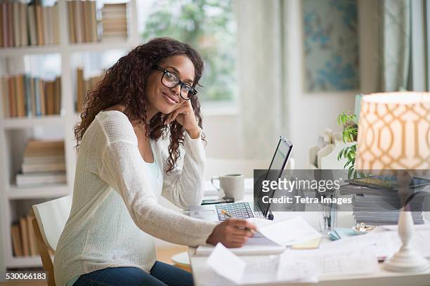 usa, new jersey, jersey city, woman using laptop in home office - african american money stock pictures, royalty-free photos & images