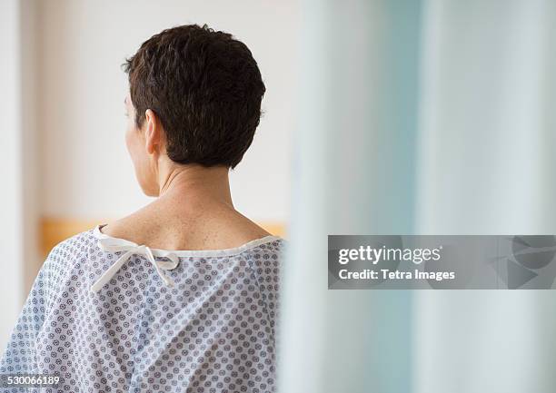 usa, new jersey, jersey city, rear view of senior woman wearing hospital gown - hospital gown imagens e fotografias de stock