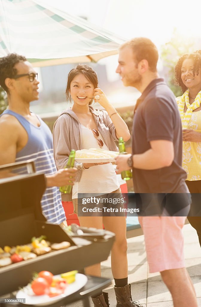 USA, New Jersey, Jersey City, Group of friends enjoying barbeque