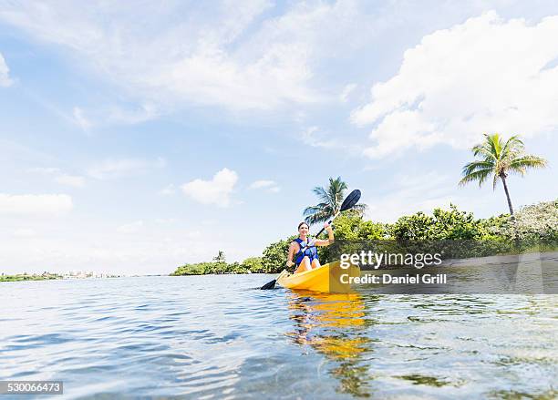 usa, florida, jupiter, woman kayaking - kayaking florida stock pictures, royalty-free photos & images