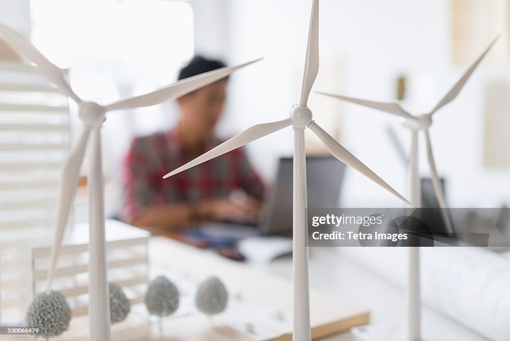 USA, New Jersey, Jersey City, Wind turbine models on desk, architect in background