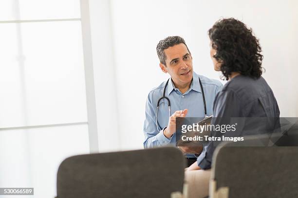 usa, new jersey, doctor talking to patient - back lit doctor stock pictures, royalty-free photos & images