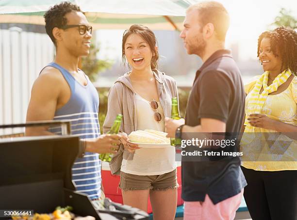 usa, new jersey, jersey city, group of friends enjoying barbeque - barbeque party woman stock-fotos und bilder