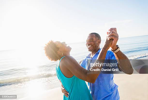 usa, florida, jupiter, mature couple dancing on beach - florida beaches 個照片及圖片檔