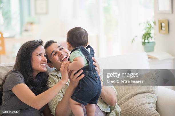 usa, new jersey, jersey city, family with baby son (6-11 months) in living room - egyptian family stock pictures, royalty-free photos & images