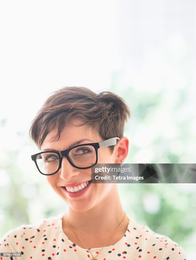 USA, New Jersey, Jersey City, Portrait of smiling woman wearing eyeglasses