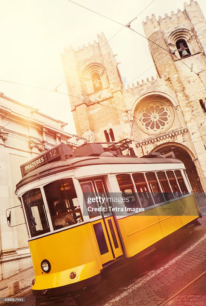 Portugal, Lisbon, Tram in front of Lisbon Cathedral
