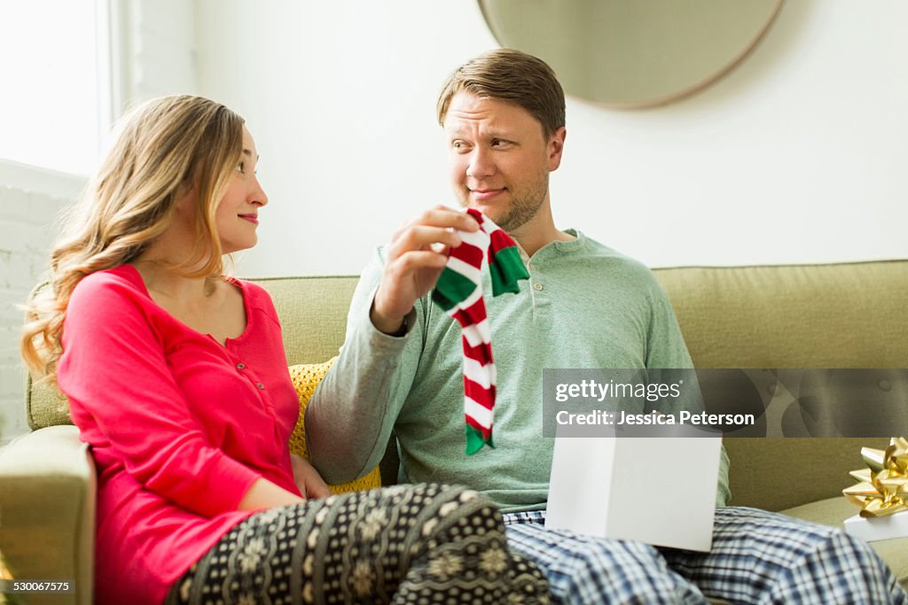 Man holding unwanted Christmas gift