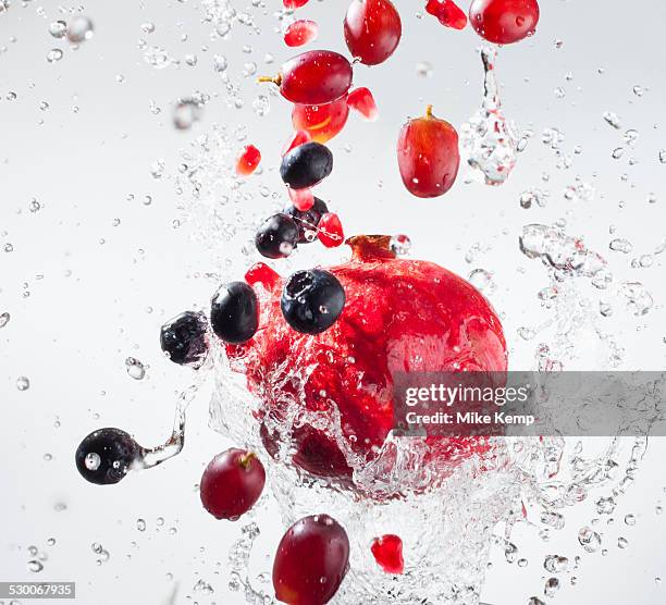 droplets splashing on fruits - frozen action stock pictures, royalty-free photos & images