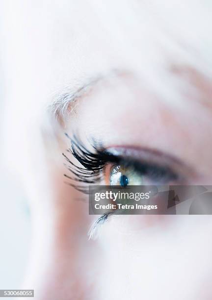 close-up of woman's eye - blonde blue eyes stock pictures, royalty-free photos & images