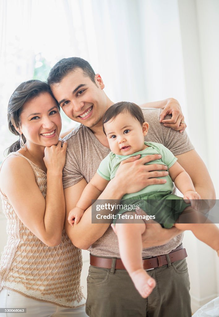 USA, New Jersey, Jersey City, Family with baby son (6-11 months) in bedroom