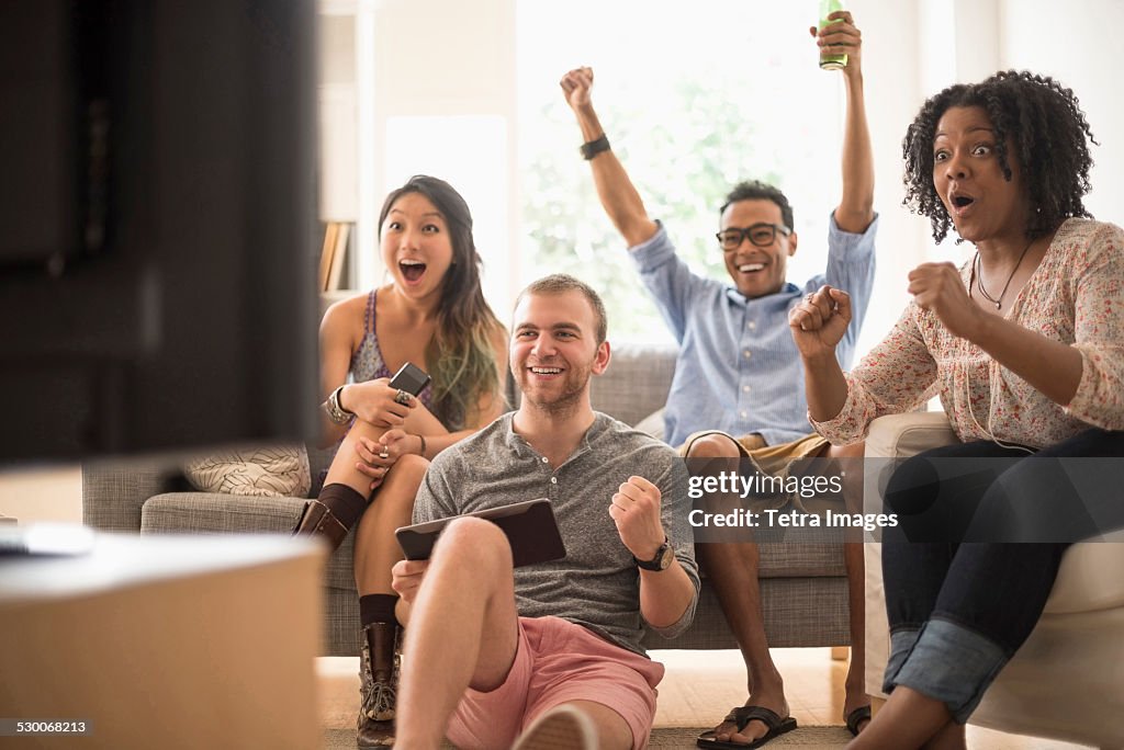 USA, New Jersey, Jersey City, Group of friends watching television