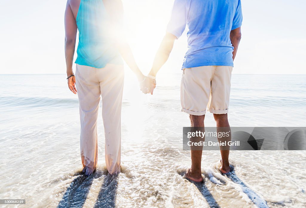 USA, Florida, Jupiter, Mature couple standing in sea