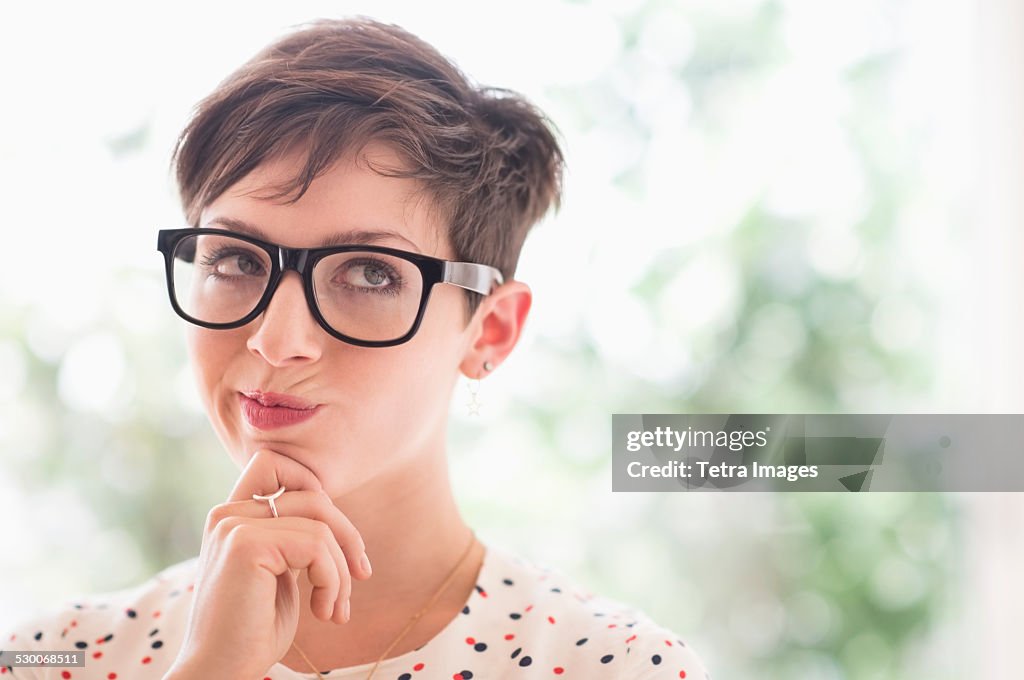 USA, New Jersey, Jersey City, Portrait of smiling woman wearing eyeglasses