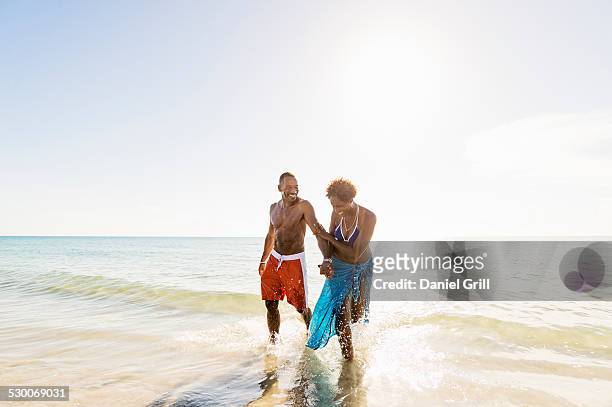 usa, florida, jupiter, mature couple walking in sea - jupiter florida foto e immagini stock