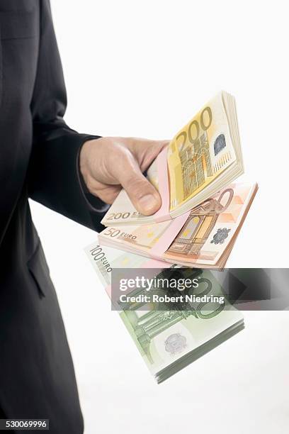 businessman holding euro banknotes, bavaria, germany - two hundred euro banknote stock pictures, royalty-free photos & images