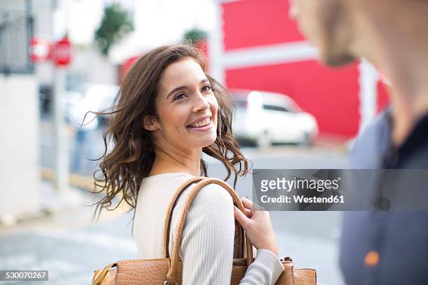 portrait of smiling woman with meeting a friend on the street - flirting stockfoto's en -beelden
