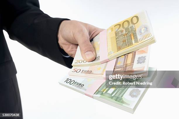 businessman holding euro banknotes, bavaria, germany - two hundred euro banknote stock pictures, royalty-free photos & images