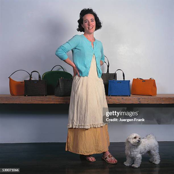 Handbag designer Kate Spade is photographed with her pet Maltese for German Elle in September 1996 in New York City. A collection of purses sit on a...