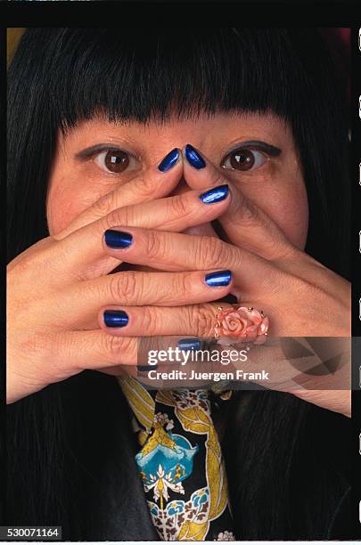 Designer Anna Sui Covering Face