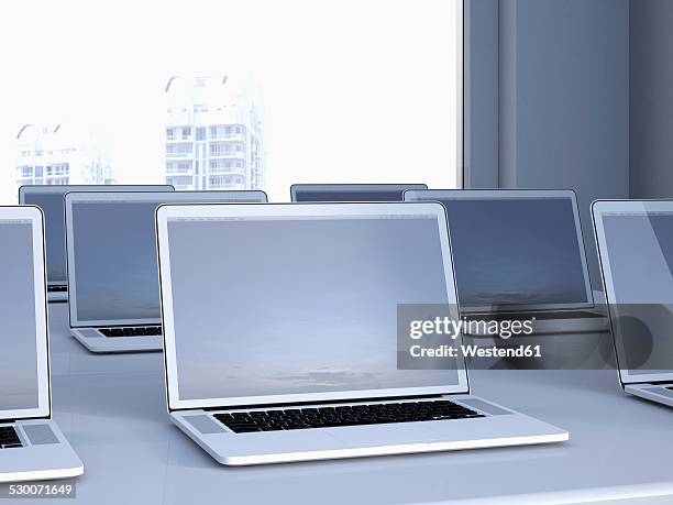 opened laptops on a table in a n office, 3d rendering - laptops in a row stock pictures, royalty-free photos & images