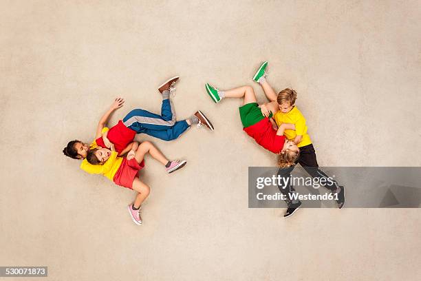 children wrestling with each other - girl wrestling stock pictures, royalty-free photos & images