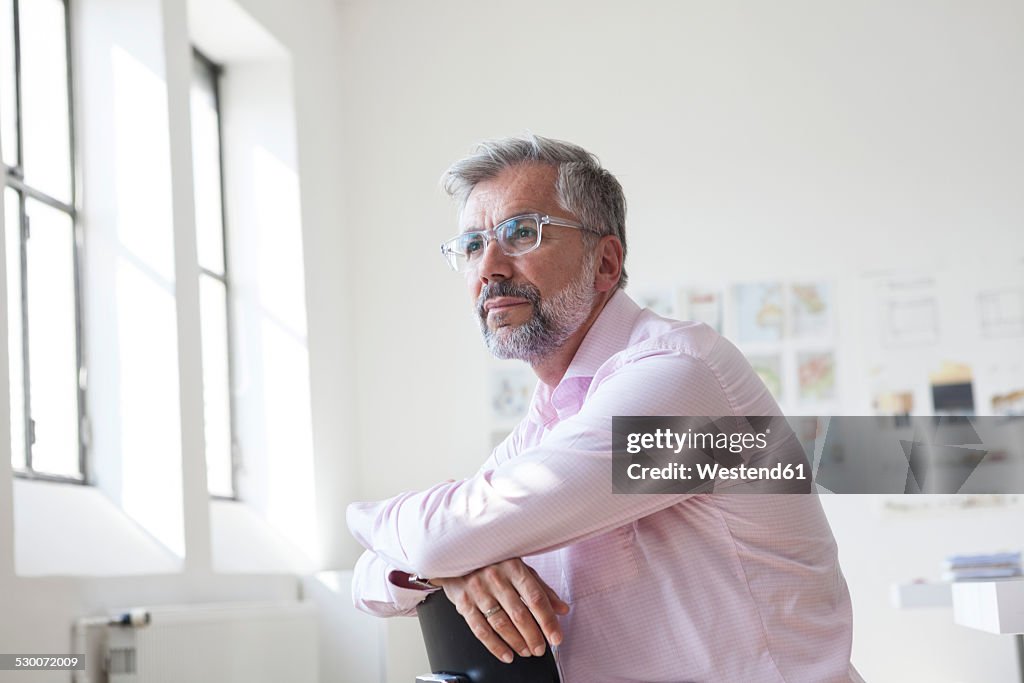 Portrait of pensive businessman sitting in an office