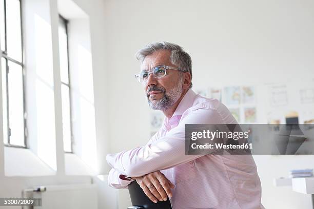 portrait of pensive businessman sitting in an office - shirt side view stock pictures, royalty-free photos & images