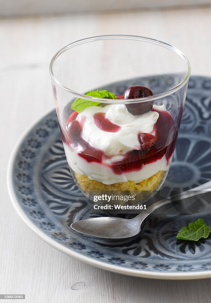 Cream cheese and cherry cake in a glass