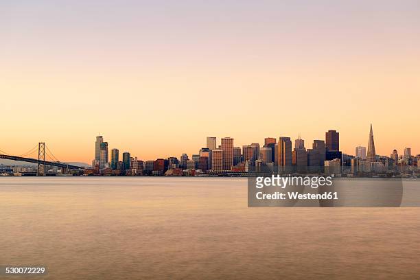 usa, california, san francisco, oakland bay bridge and skyline of financial district in morning light - skyline san francisco stock pictures, royalty-free photos & images