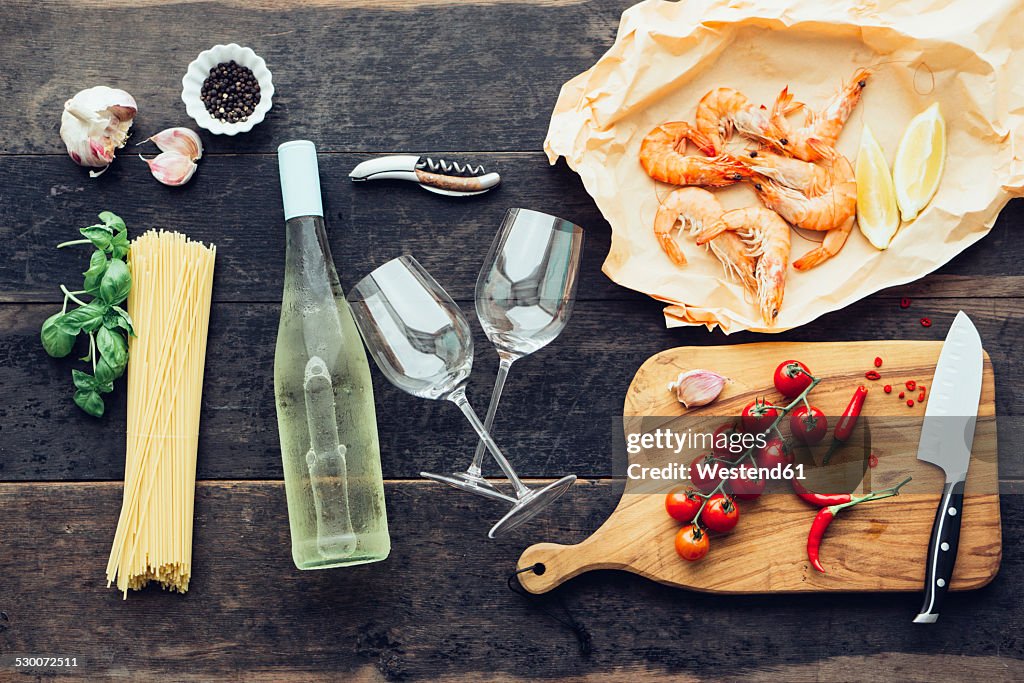 Ingredients for pasta dish with prawns, tomatoes and white wine