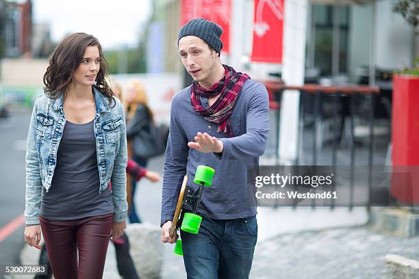 young couple walking in the city - narrating stock pictures, royalty-free photos & images