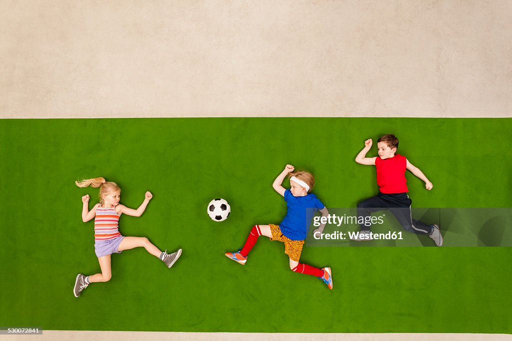 Children playing soccer in park