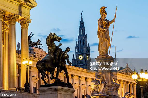 austria, vienna, view to parliament building, town hall tower and statue of goddess pallas athene by twilight - vienna foto e immagini stock