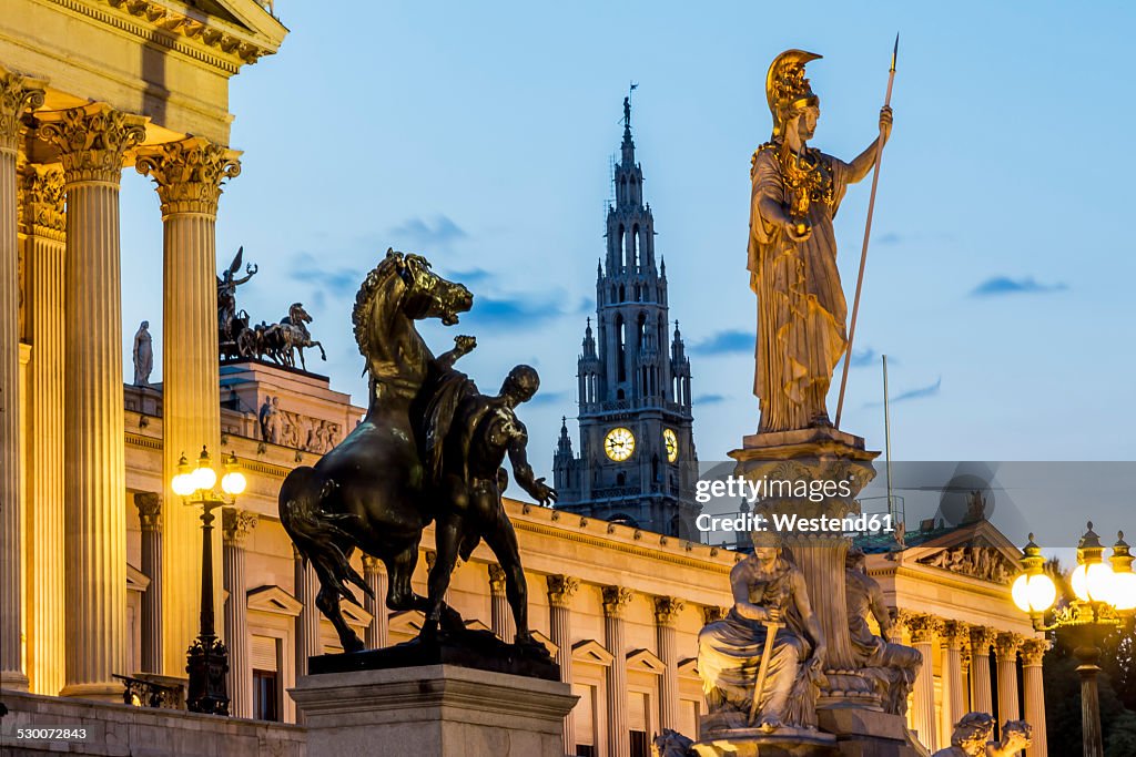Austria, Vienna, view to parliament building, town hall tower and statue of goddess Pallas Athene by twilight