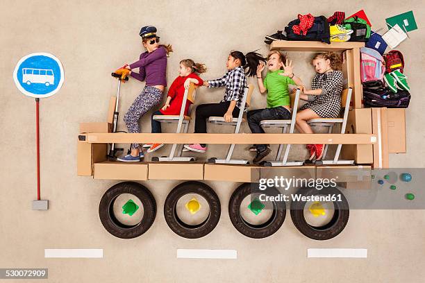 school children in school bus - kids sitting together in bus stock-fotos und bilder