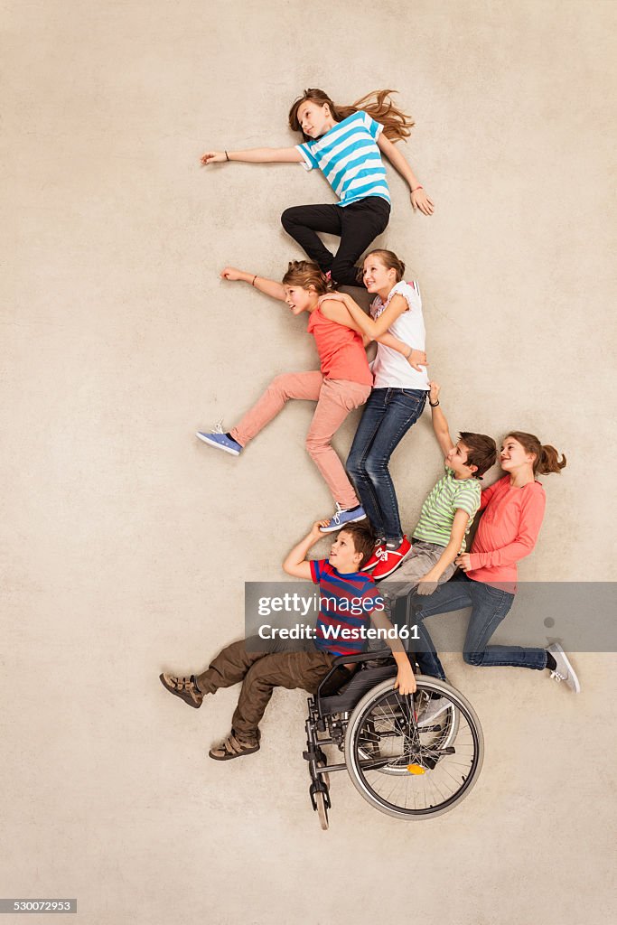 Children having fun with handicapped friend