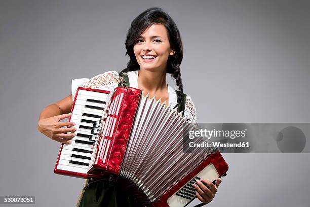 portrait of smiling young woman playing accordion - accordionist - fotografias e filmes do acervo