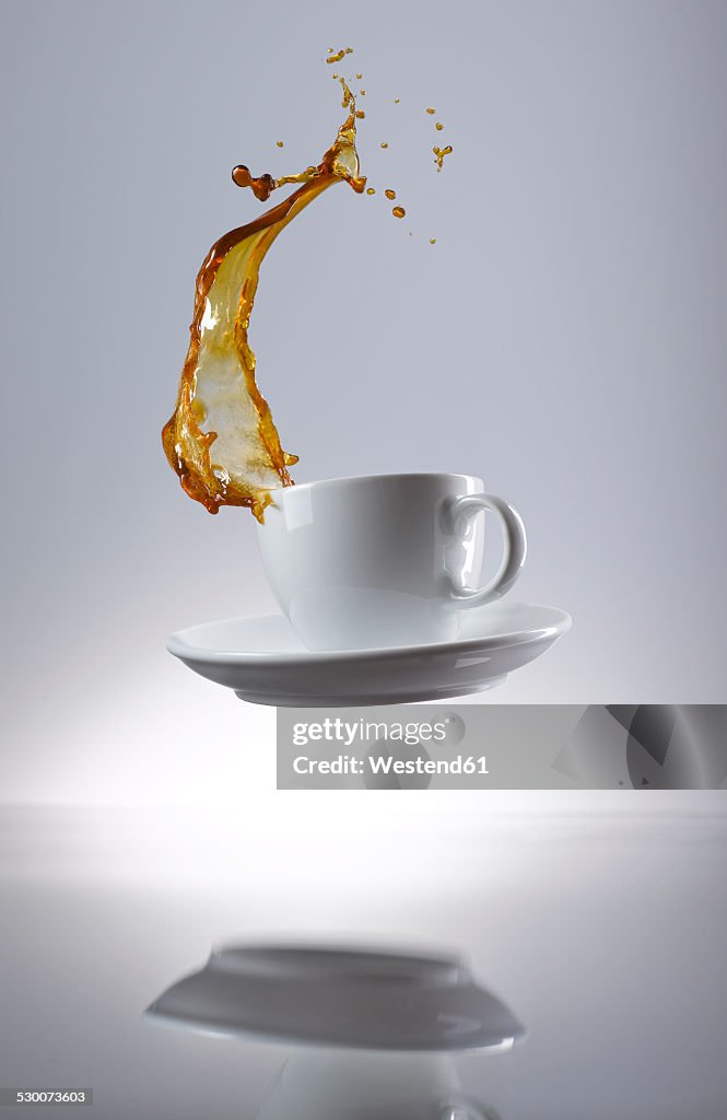 Coffee splashing in cup