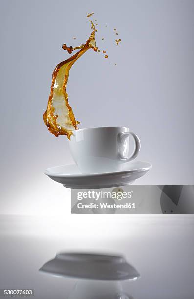 coffee splashing in cup - spilled drink stock pictures, royalty-free photos & images