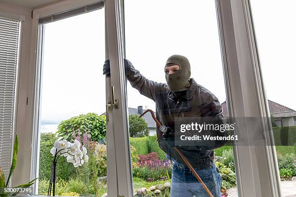 burglar trying to get into house - burglary stock pictures, royalty-free photos & images