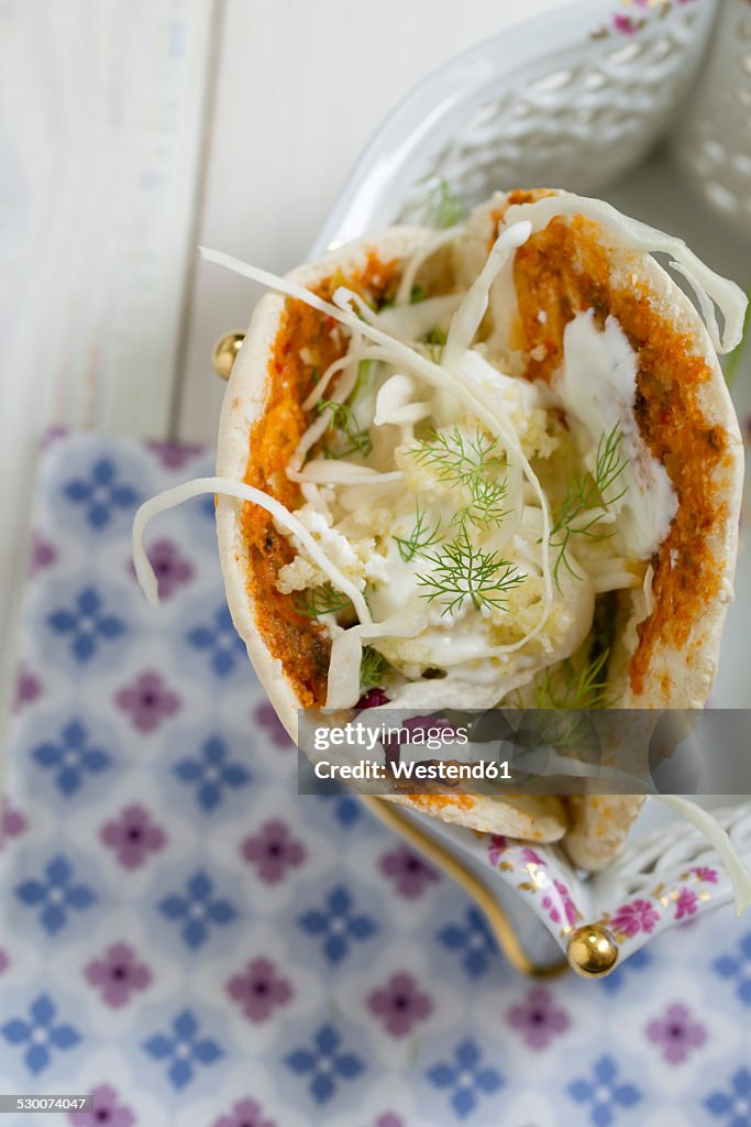 Pita bread filled with millet salad, white cabbage, yoghurt dressing and dill