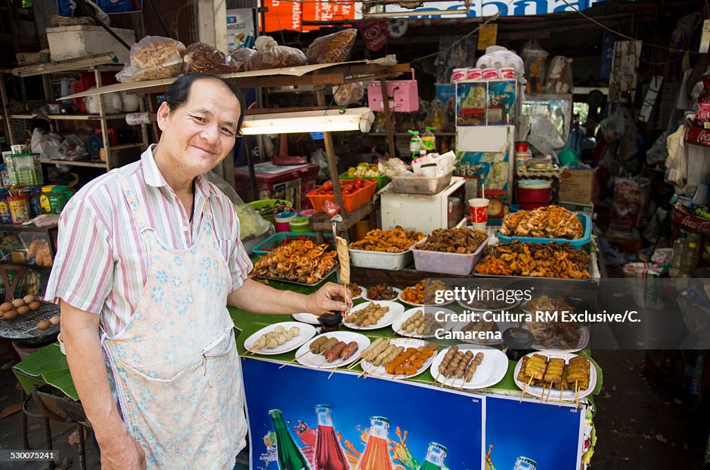 Man at stall selling snacks, Chiang Mai, Thailand