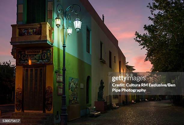 view of quaint narrow building at night, el caminito, la boca, buenos aires, argentina - la boca stock pictures, royalty-free photos & images