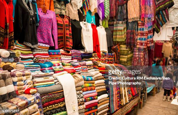 rows of textiles on market stall, pisac, peru, south america - pisac imagens e fotografias de stock