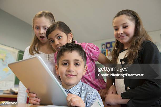 school children using a digital tablet in a classroom, munich, bavaria, germany - kurdish girl - fotografias e filmes do acervo