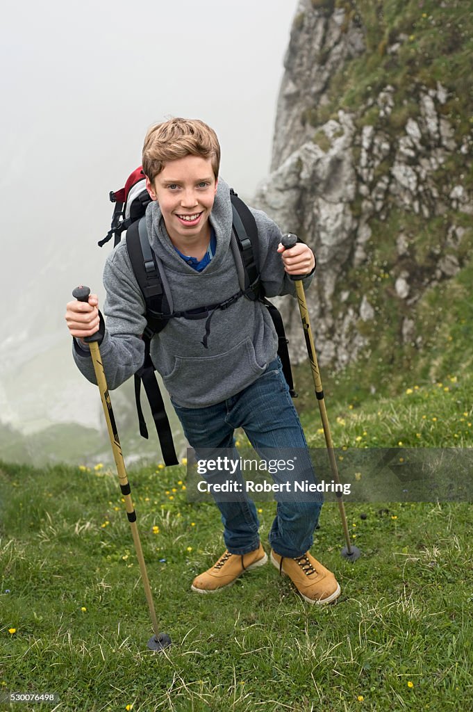 Teenage boy hiking in mountains Alps