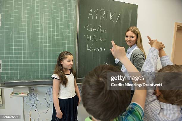 female teacher teaching students in classroom, munich, bavaria, germany - kurdish girl foto e immagini stock