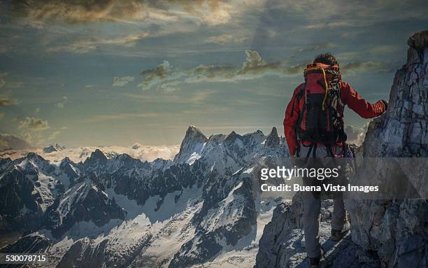 climber watching a mountain range - terreno accidentato foto e immagini stock